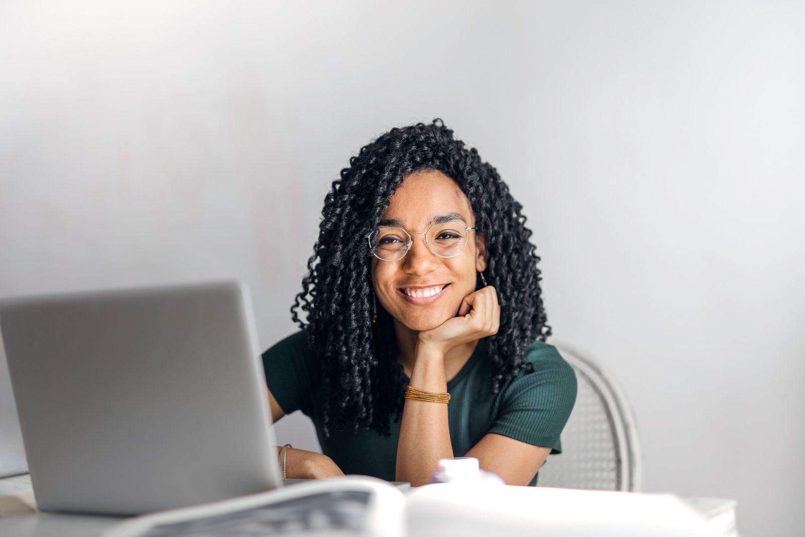 A professional woman working confidently at a laptop