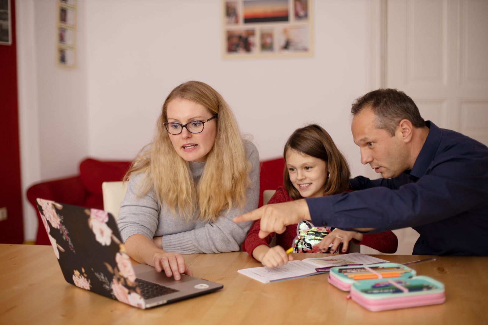 A family learning together with a laptop at home