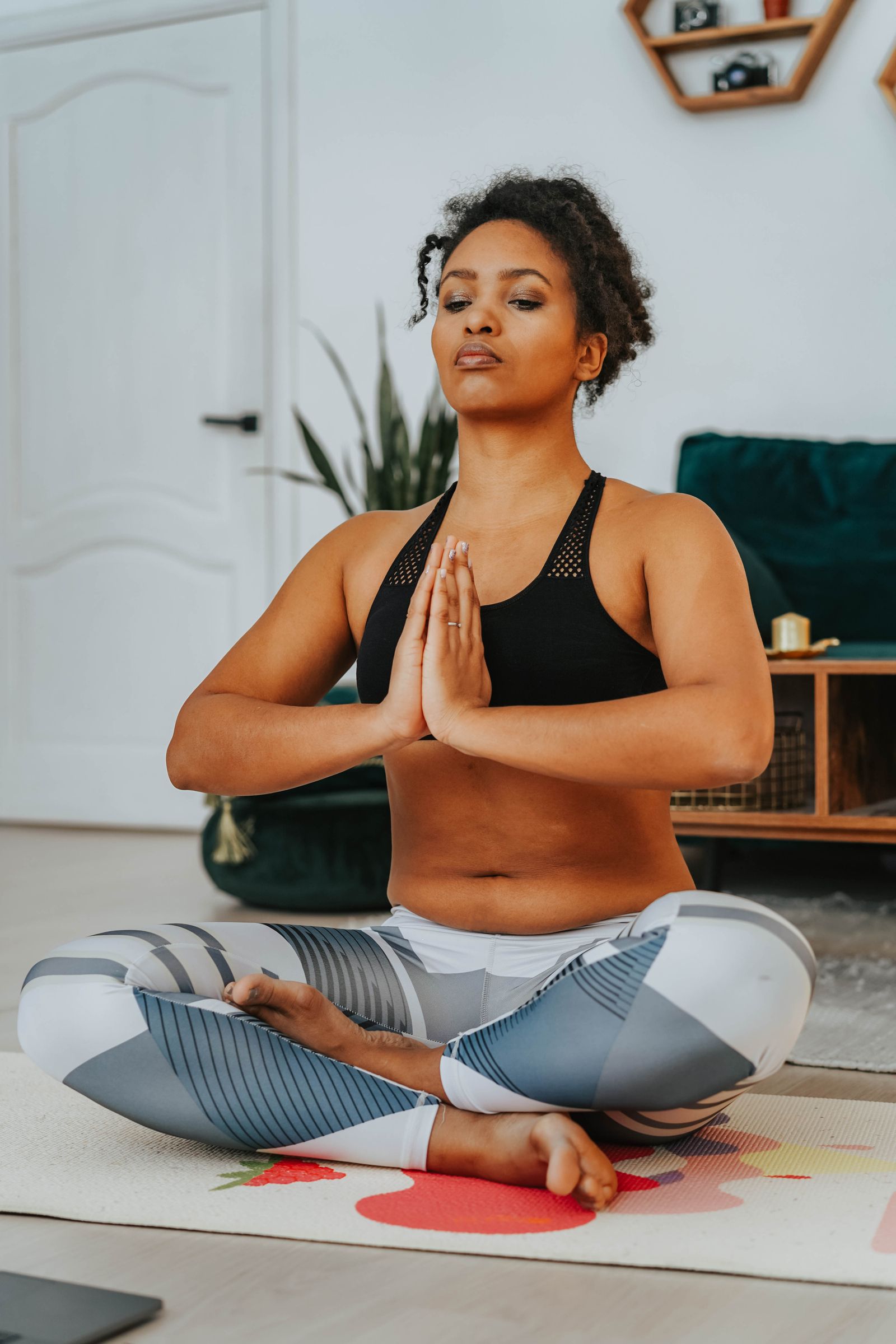 A woman meditating in lotus position on a yoga mat, embracing calm and mindfulness