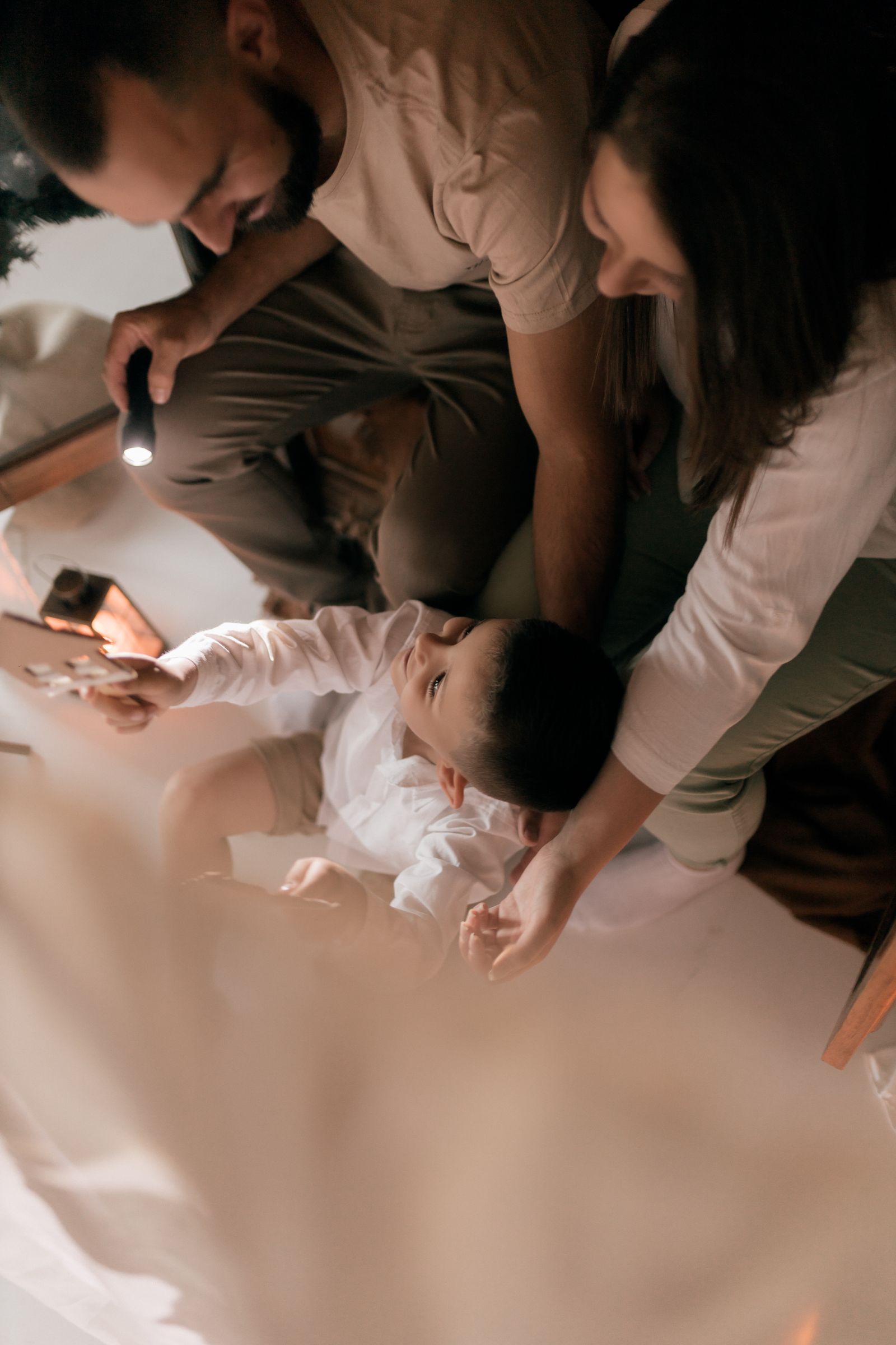 A family sharing a warm moment together with a flashlight, symbolizing preparedness and togetherness