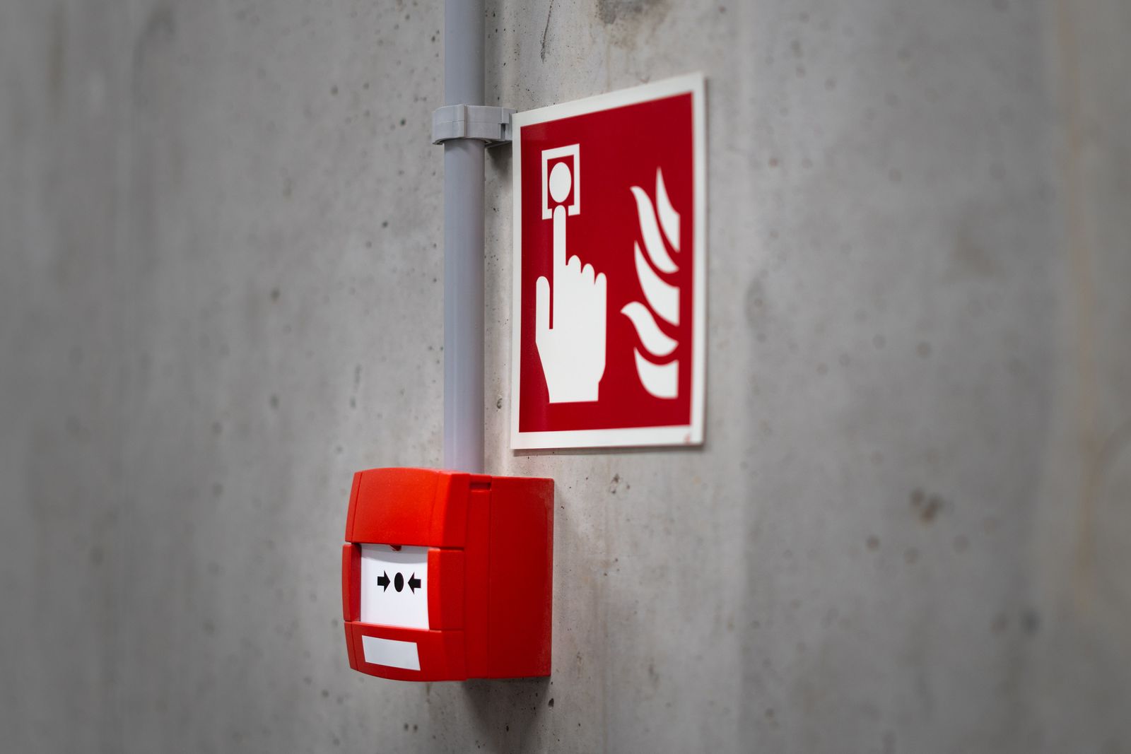 A red fire alarm mounted on a wall, a reminder to check home fire safety devices